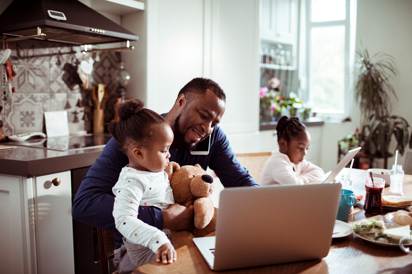 https://tickertapecdn.tdameritrade.com/assets/images/pages/md/Father and daughters in the kitchen: Child tax credit and what it means for parents