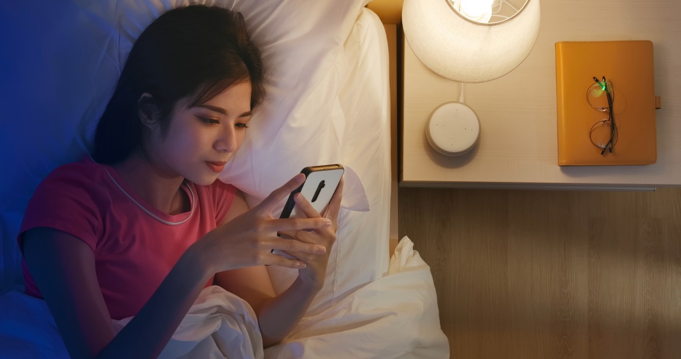 https://tickertapecdn.tdameritrade.com/assets/images/pages/md/Woman with smartphone in bed: Should you invest in sleep stocks?
